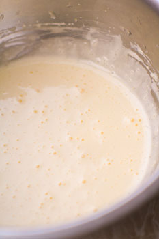 Сливки смешиваем с молоком и цедрой апельсина, на медленном огне доводим до кипения и остужаем. отдельно яичные желтки взбиваем с сахаром в пышную белую пену.