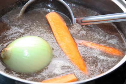 В сотейник или кастрюлю перекладываем сырое грибное пюре, туда же кладем луковицу, которую разрезаем пополам и разрезанную вдоль морковь. Ставим  все тушить под крышкой на небольшом огне около получаса. Затем вынимаем лук и морковь.