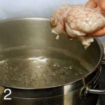 В кастрюле вскипятить подсоленную воду. Мозги тщательно промыть, положить в кастрюлю и варить 7 мин. Переложить шумовкой на блюдо и дать немного остыть.