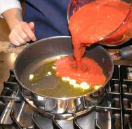 Как только чеснок начнёт менять окраску, добавить помидоры, соль и перец