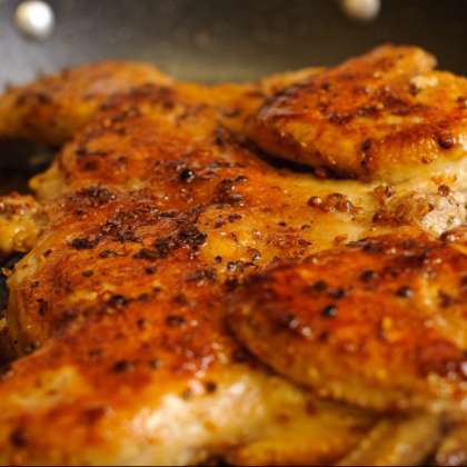 После того, как курица станет красивого золотисто-коричневатого цвета, уменьшите огонь до средне-низкого. Добавьте немного воды и накройте крышкой. Держите курицу в сковороде 4 минуты, переверните и готовьте еще 4 мин.