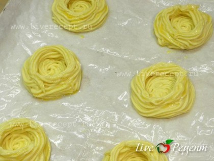 С помощью кулинарного шприца выдавливаем картофельное пюре в виде корзиночек на  подготовленную бумагу для выпечки. Корзиночки смазываем желтком.