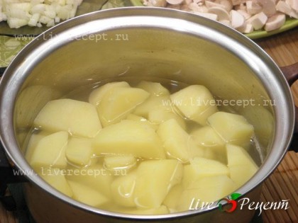 Чтобы приготовить суп-пюре с шампиньонами, картофель чистим и нарезаем произвольно. Заливаем водой так чтобы она только покрывала картофель, солим и отвариваем до готовности.