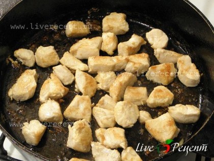 Для приготовления курицы по-испански разогреваем масло в большой сковороде и обжариваем порезанную курицу до румяной корочки.
