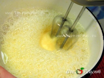 Для приготовления блинного торта сначала печем блины. Желтки отделяем от белков. Белки убираем в холодильник. Желтки взбиваем с сахаром, добавляем молоко и еще раз взбиваем при помощи миксера в течение 1 мин.