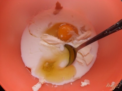 В миску влить кефир комнатной температуры, добавить яйцо, соль, сахар, дрожжи, растительное масло и сливочное масло.
