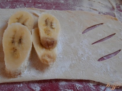 На середину неразрезанной стороны сыплем немного сахара. Если киви спелый, то можно обойтись и без сахара. На сахар выкладываем очищенный и порезанный на кружочки банан.