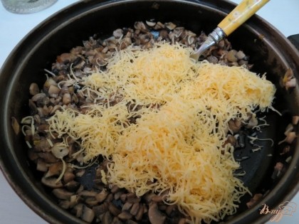 К грибам и луку добавим вторую половину сыра.