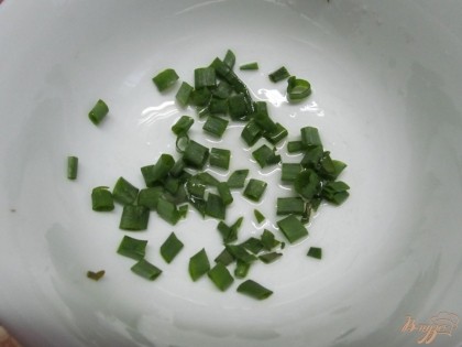Салатник смазать маслом и выложить половину зеленого лука.