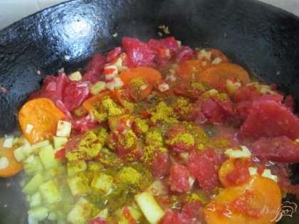 В сковороду добавить томат (у меня замороженный) и специи карри. Довести до кипения и выгрузить в кастрюлю к картофелю с рисом. Посолим и поперчим. Доводим до кипения и снимаем с огня.