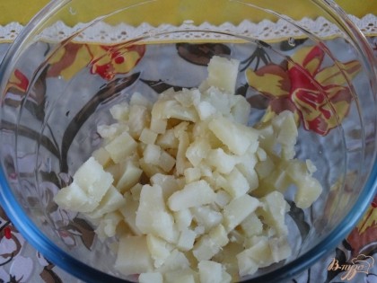 Картофель отвариваем и режем кубиками, выкладываем его в салатник.