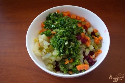 Все нарезанные овощи и измельченную зелень помещаем в миску.