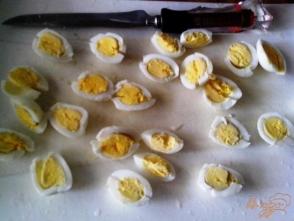 Предварительно отварить перепелиные яйца. Остудить и нарезать их вдоль на 4 части.