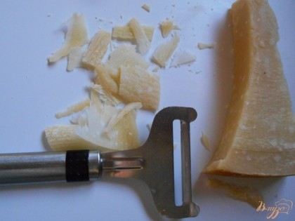Сыр пармезан или Грана Падана нарезать при помощи ножа на крупные но тонкие полосы.