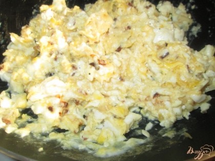 Жарить яйца до готовности, перемешивая лопаткой. В полученную массу добавить натертый чеснок и 3-4 столовых ложки майонеза.