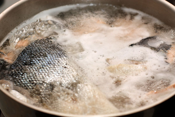 Залейте рыбу холодной водой (3-3,5л) и доведите до кипения на большом огне. Тщательно снимайте образующуюся пену до тех пор, пока она не перестанет появляться.