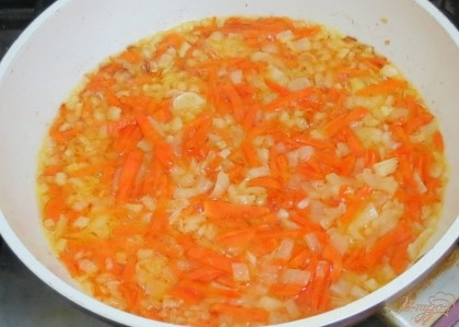 Разогреваем сковороду с оливковым маслом. Отправляем в сковороду лук и морковь и пассеруем на очень маленьком огне. В конце пассерования добавляем томатную пасту. Пассеруем вместе ещё несколько минут.