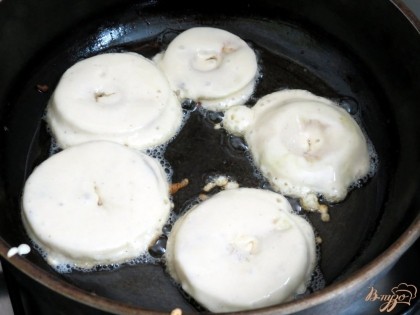 Разогреваем сковороду с растительным маслом и выкладываем на неё яблочные кольца.